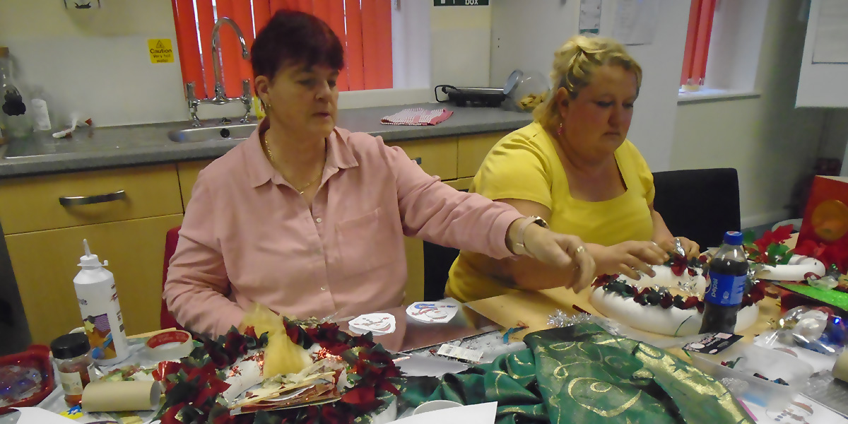 Photo of two ladies busy making Christmas decorations