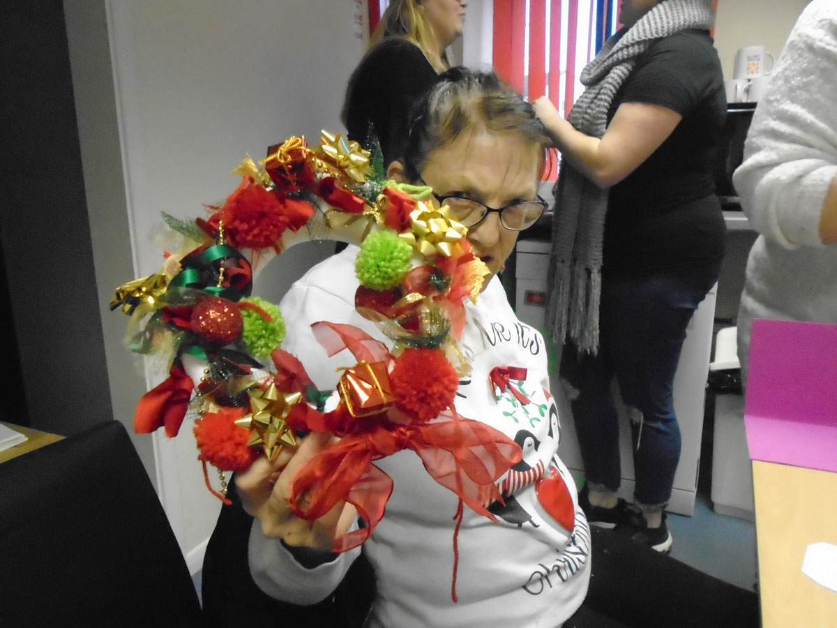 Photo of lady and her Christmas wreath
